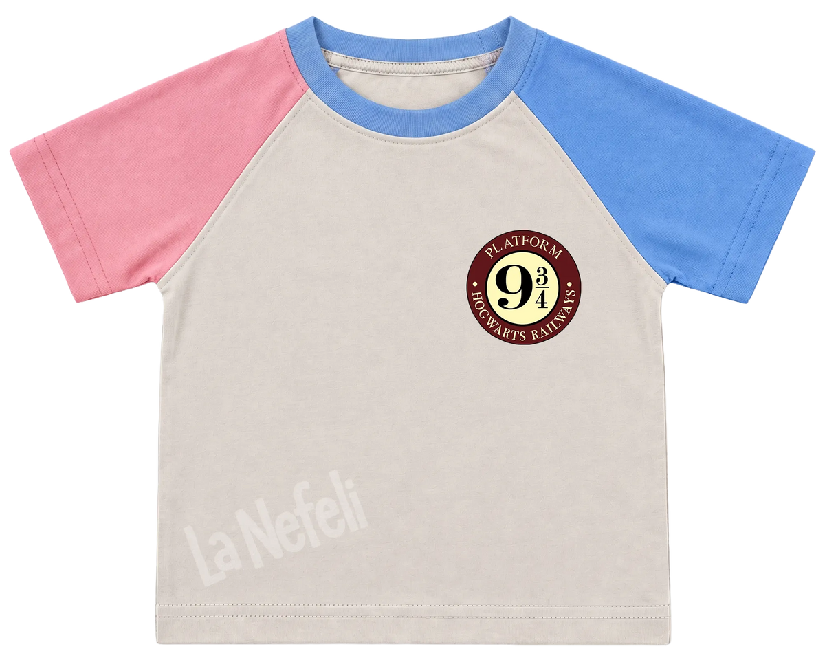 Harry Potter Hogwarts castle kids' T-shirt, pink and blue raglan sleeves, blue collar, a small Platform 9¾ badge on the chest
