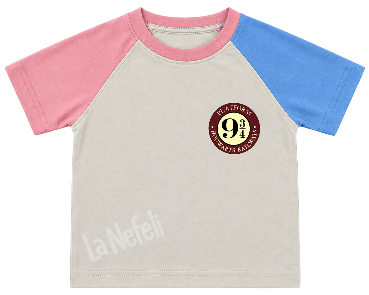 Harry Potter Hogwarts castle kids' T-shirt, pink and blue raglan sleeves, pink collar, a small Platform 9¾ badge on the chest